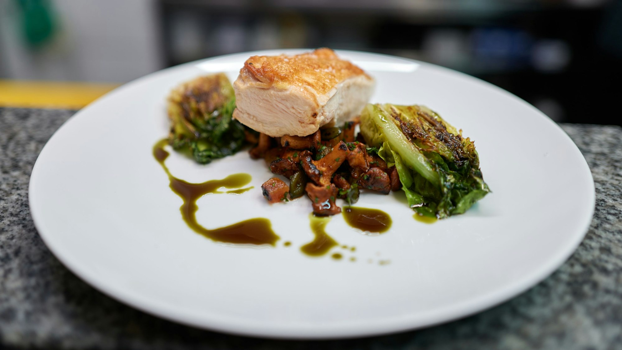 Das fertige Hauptgericht "Hühnerbrust vom Biohof mit Pfifferlingen, Romanasalat und Kürbiskernen.