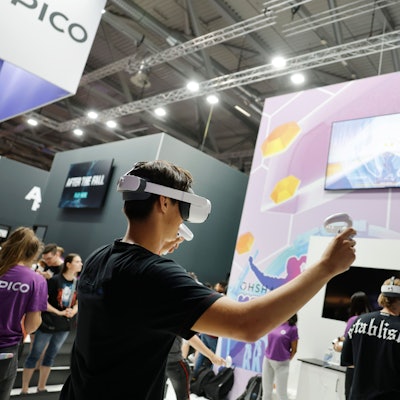 Ein Junge spielt mit VR-Brille ein Spiel auf einem Bildschirm.