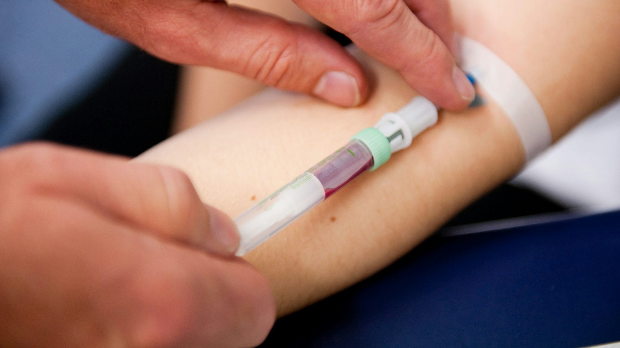 Eine Frau bekommt Blut abgenommen, Nahaufnahme