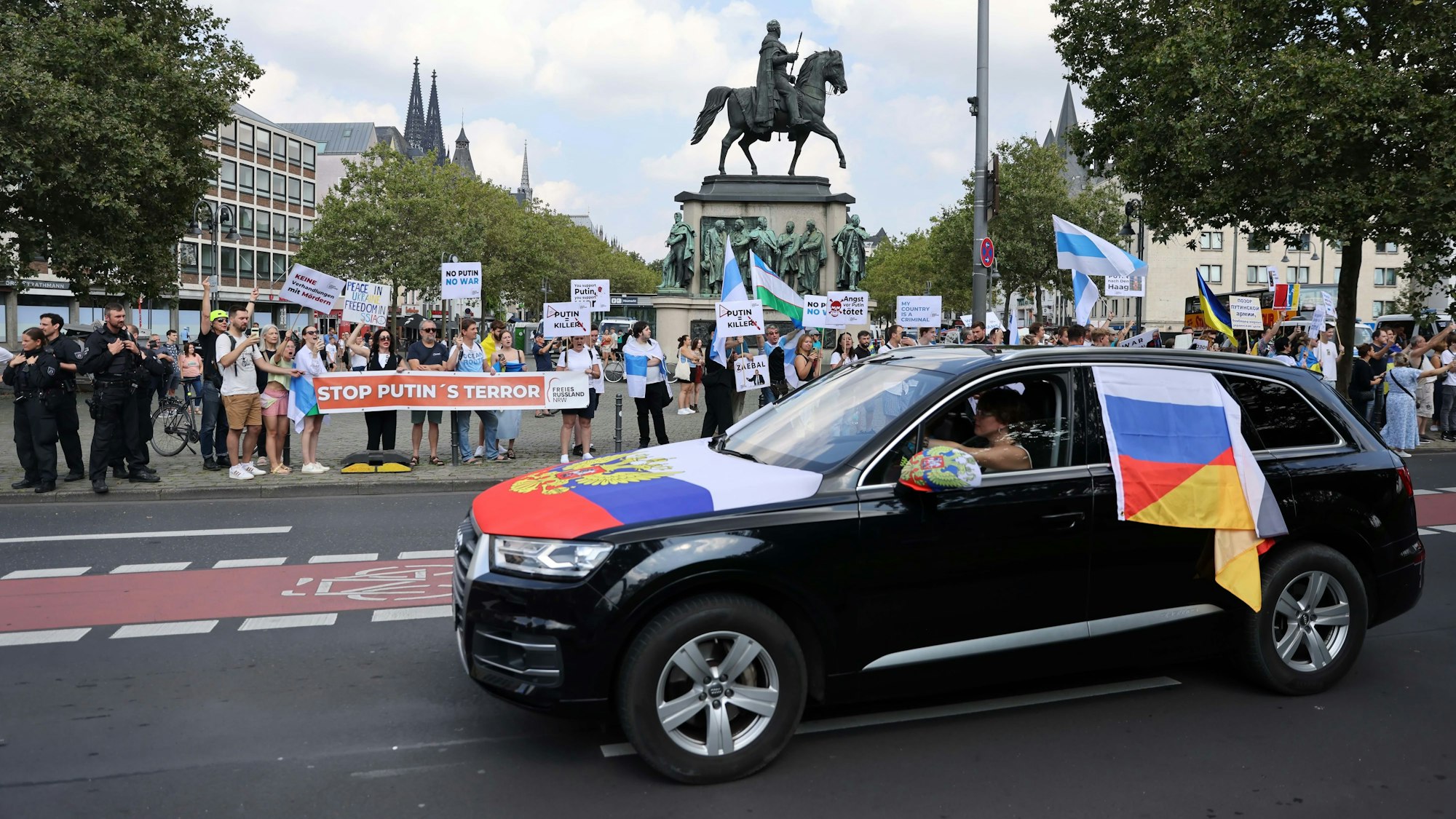 Pro-Russischer Autokorso fährt am Heumarkt vorbei, wo Gegendemonstranten warten.