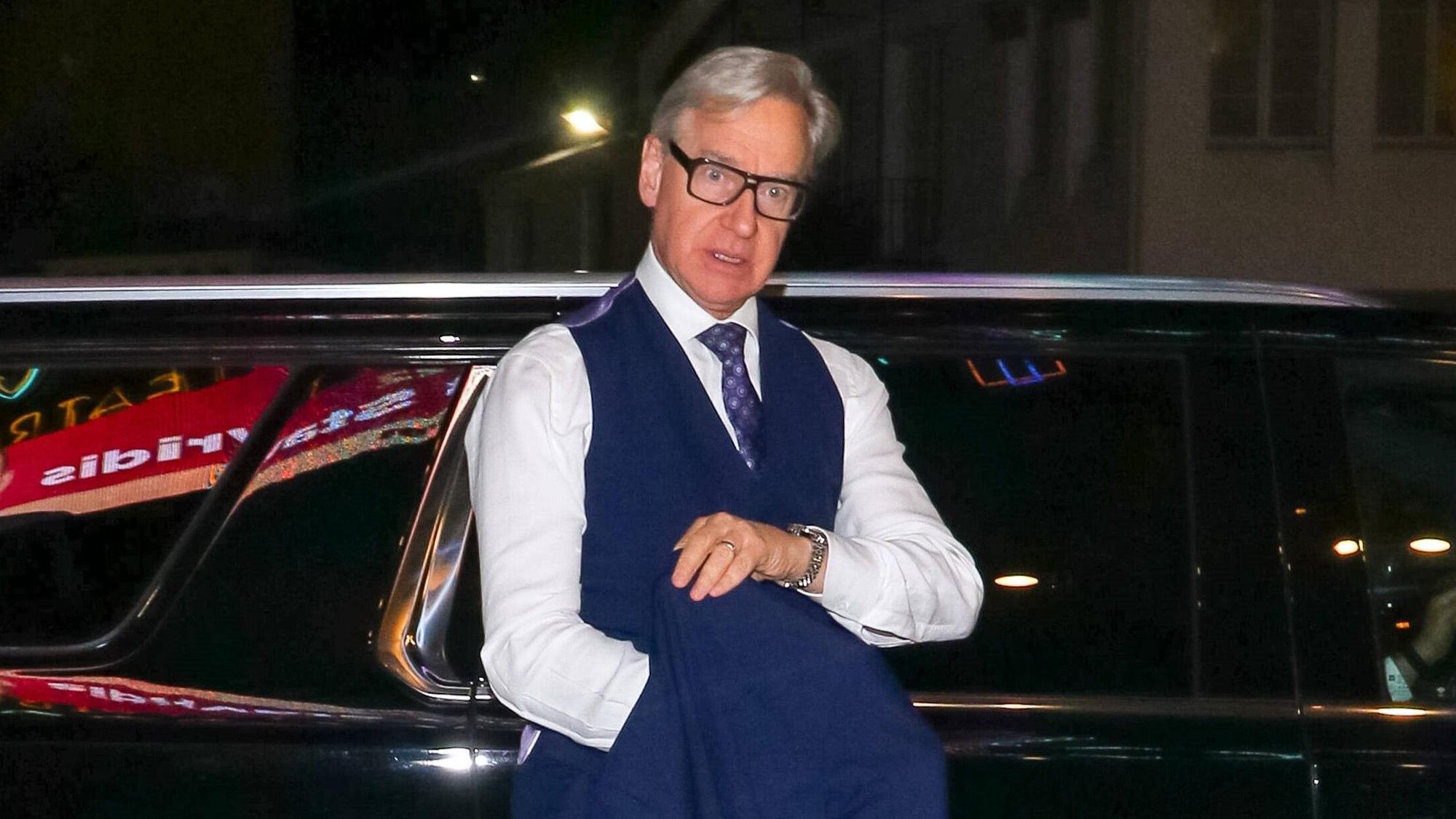 Regisseur Paul Feig lehnt an einem Auto und schaut abwesend schräg nach unten.