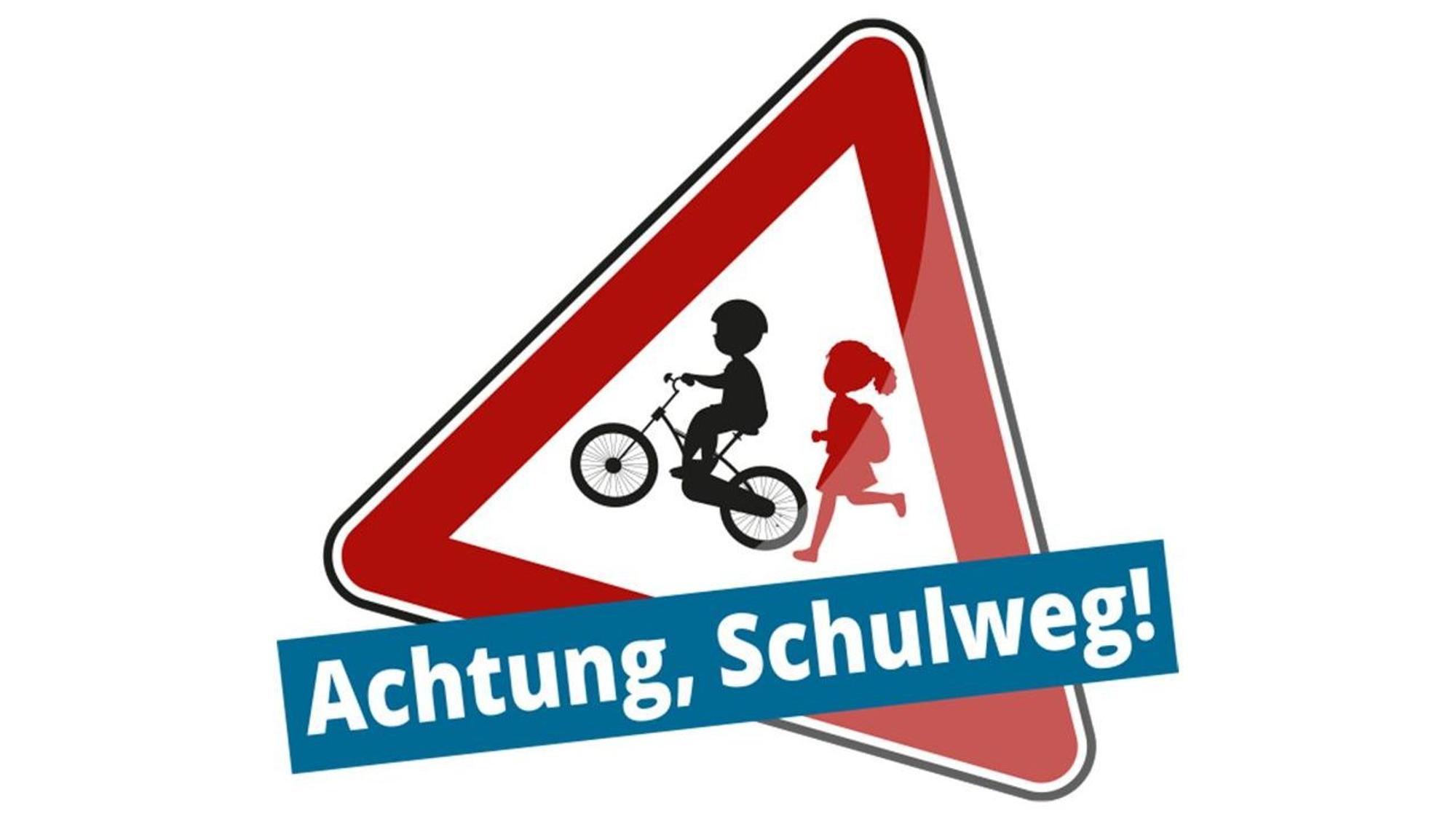 Das Logo zur Aktion „Achtung, Schulweg!“ zeigt die Silhouetten zweier Kinder in einem leicht schräg gestellten Warnschild.