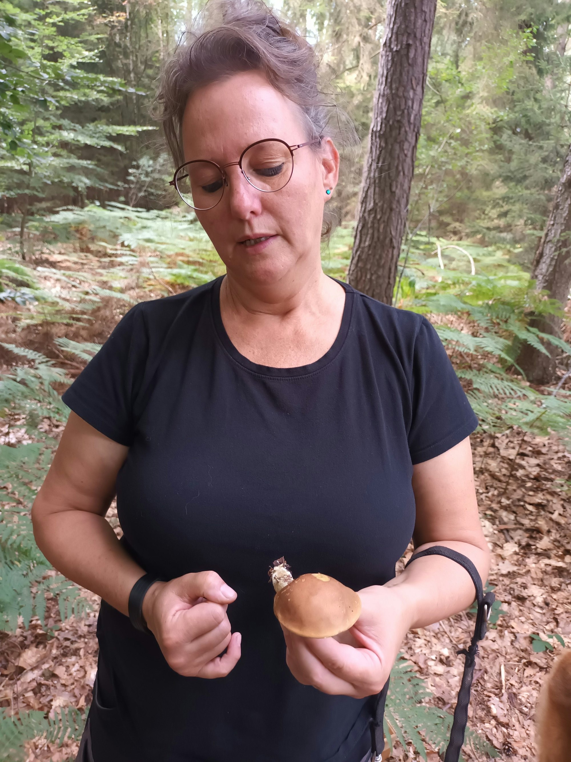 Eine Frau hält eine Marone in der Hand.