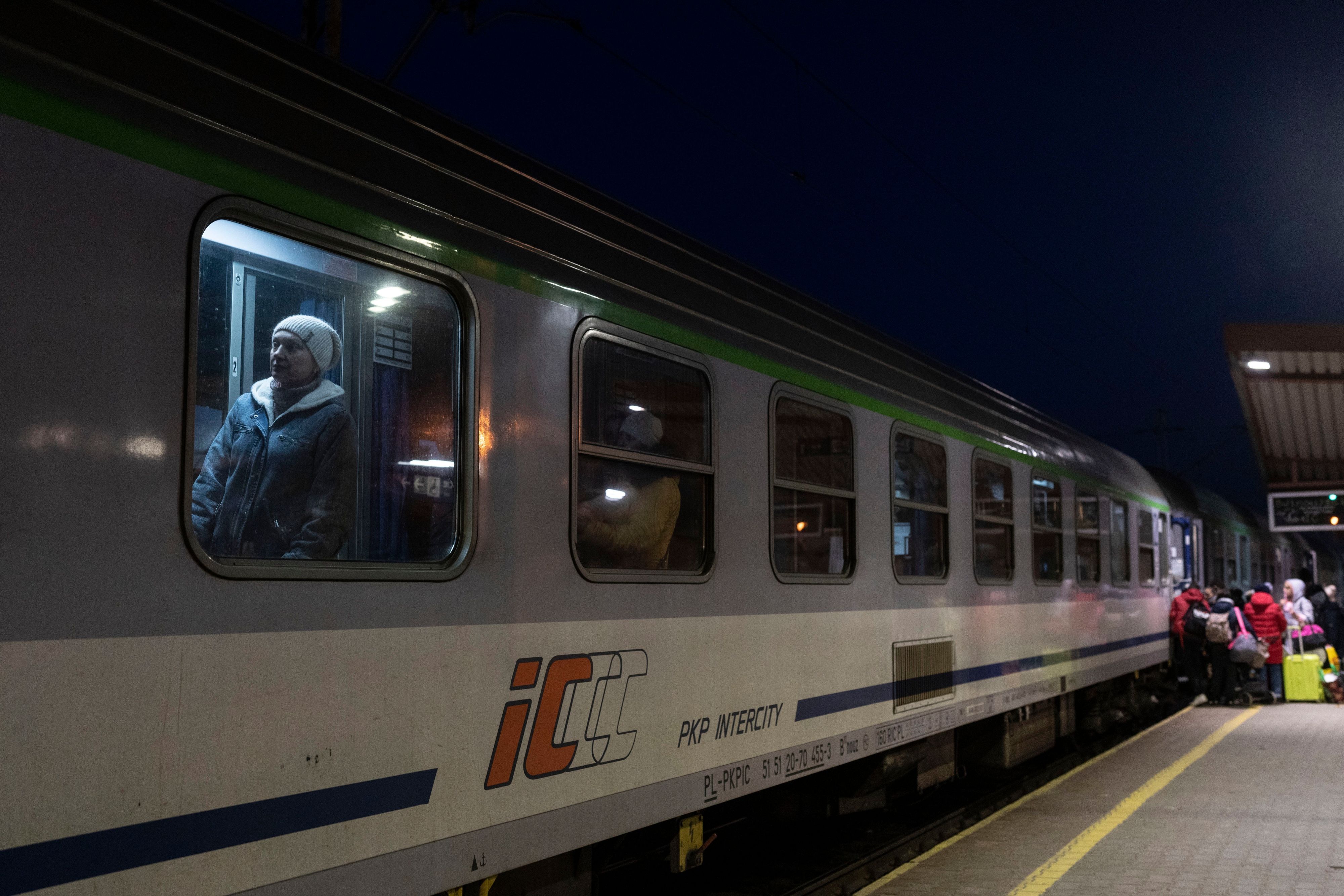 FILE - Ukrainian refugees embark a train bound to Warsaw, at the Przemysl train station, southeastern Poland, on March 11, 2022. Polish security authorities are investigating multiple cases of disruption to railway traffic, after unauthorized radio signals stopped several trains over the weekend. On some of the signals, the Russian national anthem could reportedly be heard in the background.