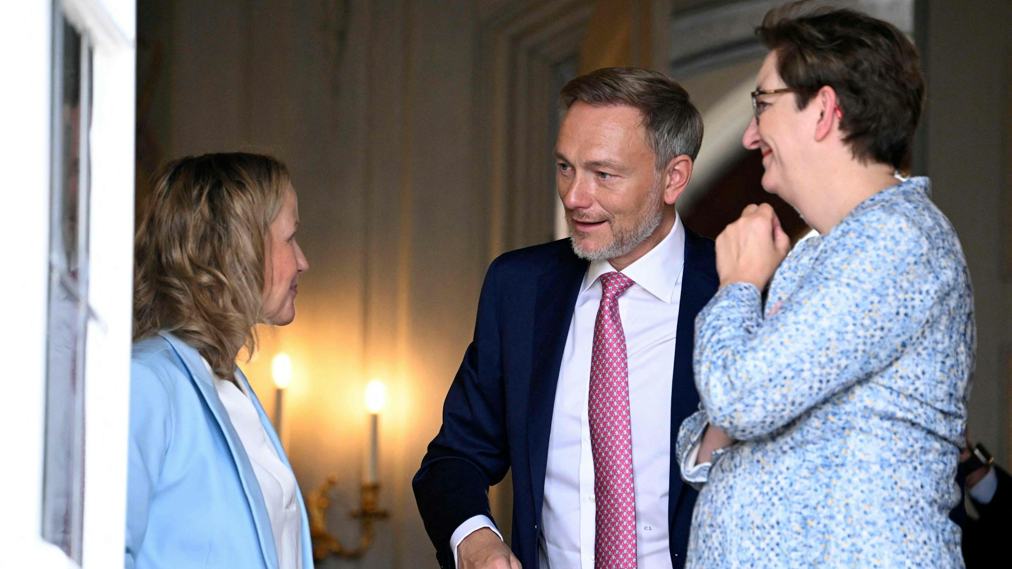 (L-R) German Minister for the Environment, Nature Conservation, Nuclear Safety and Consumer Protection Steffi Lemke, German Finance Minister Christian Lindner and German Minister for Housing, Urban Development and Building Klara Geywitz talk at Meseberg Palace on the second day of a retreat meeting of the German cabinet on August 30, 2023 in Meseberg, north of Berlin, eastern Germany. (Photo by Tobias SCHWARZ / AFP)
