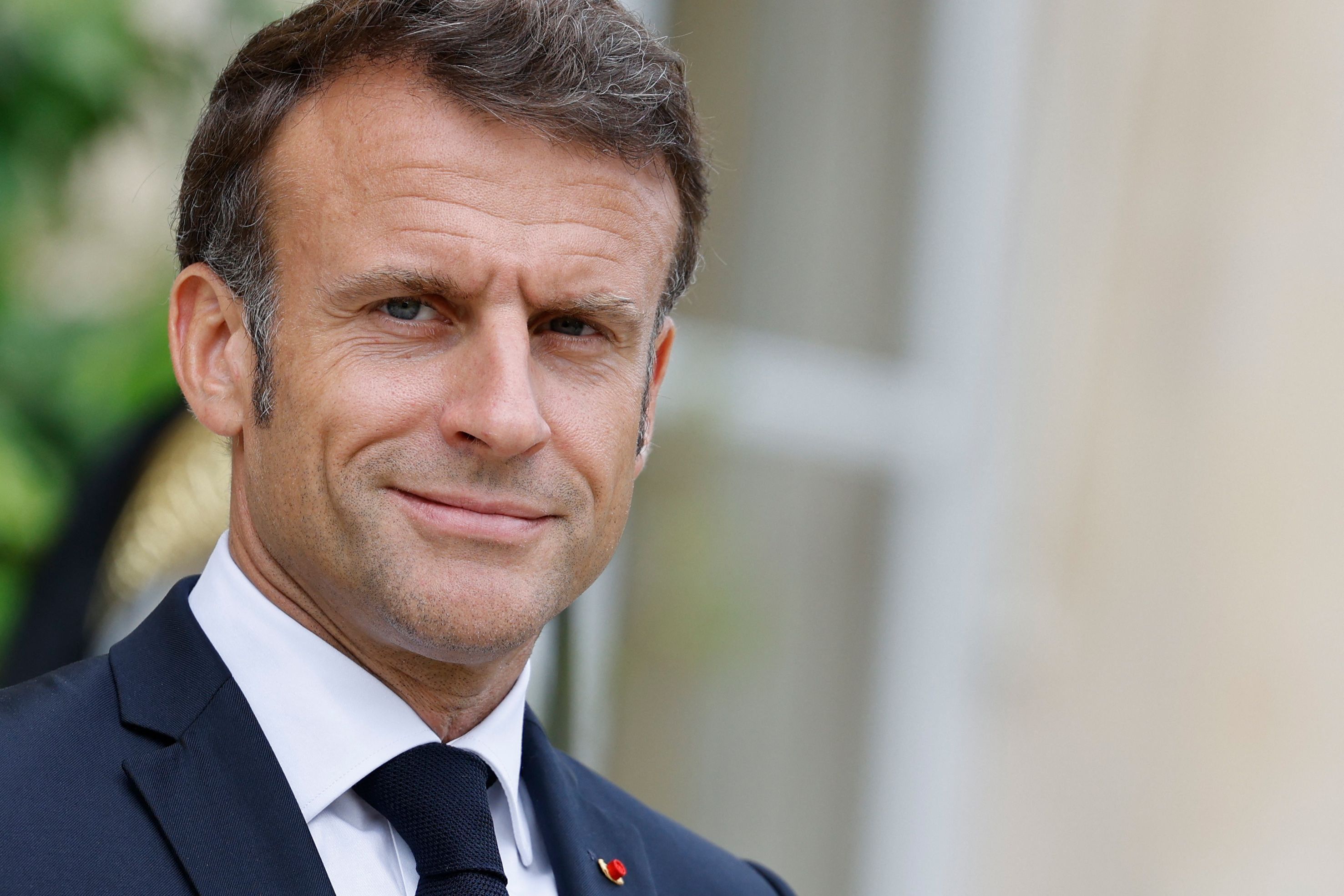French President Emmanuel Macron arrives to greet a head of state during bilateral meetings at the Elysee Palace, on the sidelines of the New Global Financial Pact Summit, in Paris, on June 22, 2023. Dozens of global leaders are gathering in Paris on June 22 for a summit to tease out a new consensus on international economic reforms to help debt-burdened developing countries face a growing onslaught of challenges, particularly climate change. (Photo by Ludovic MARIN / AFP)