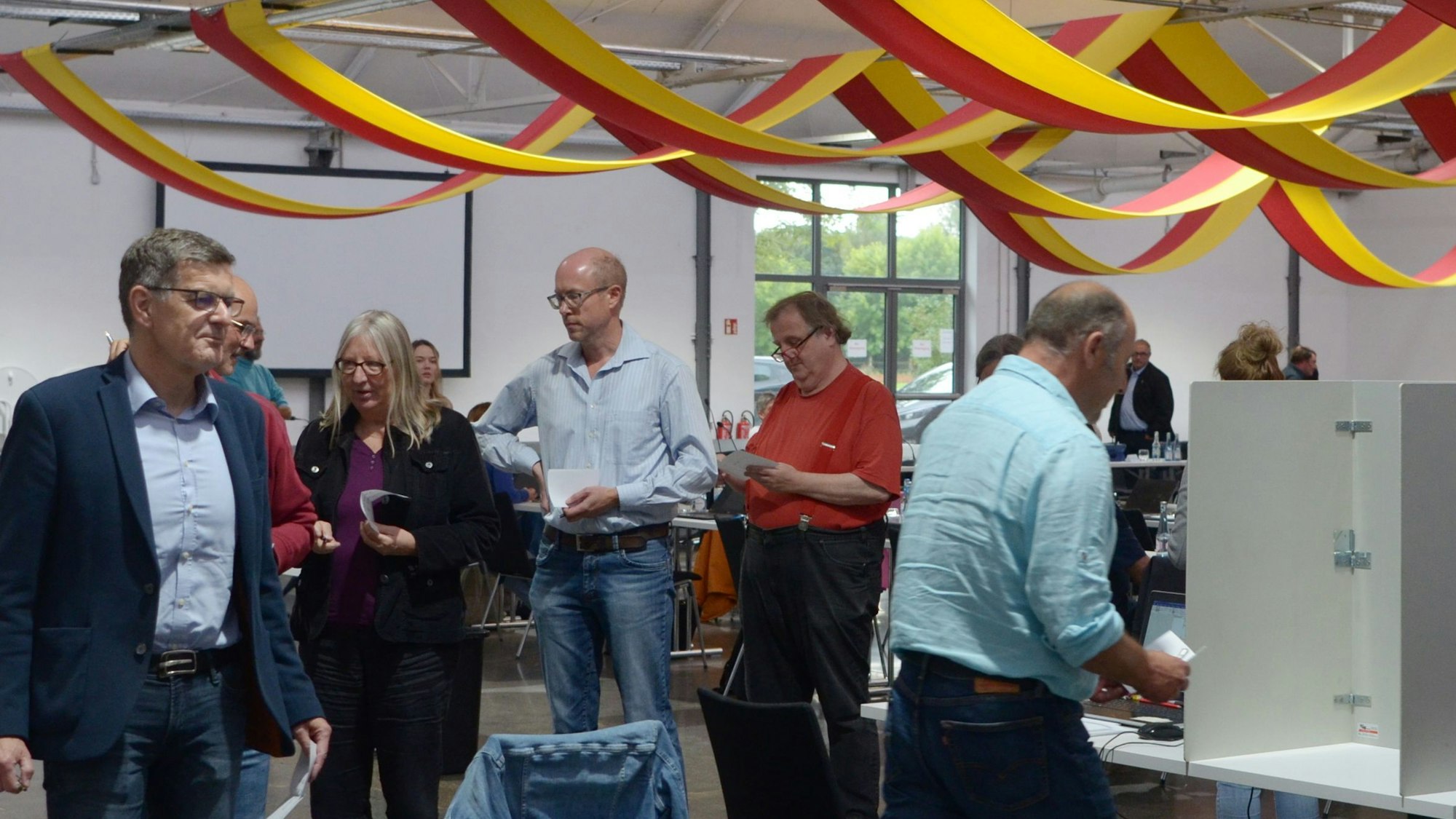 Mitglieder des Euskirchener Stadtrats haben sich aufgereiht, um an einer geheimen Abstimmung teilzunehmen.