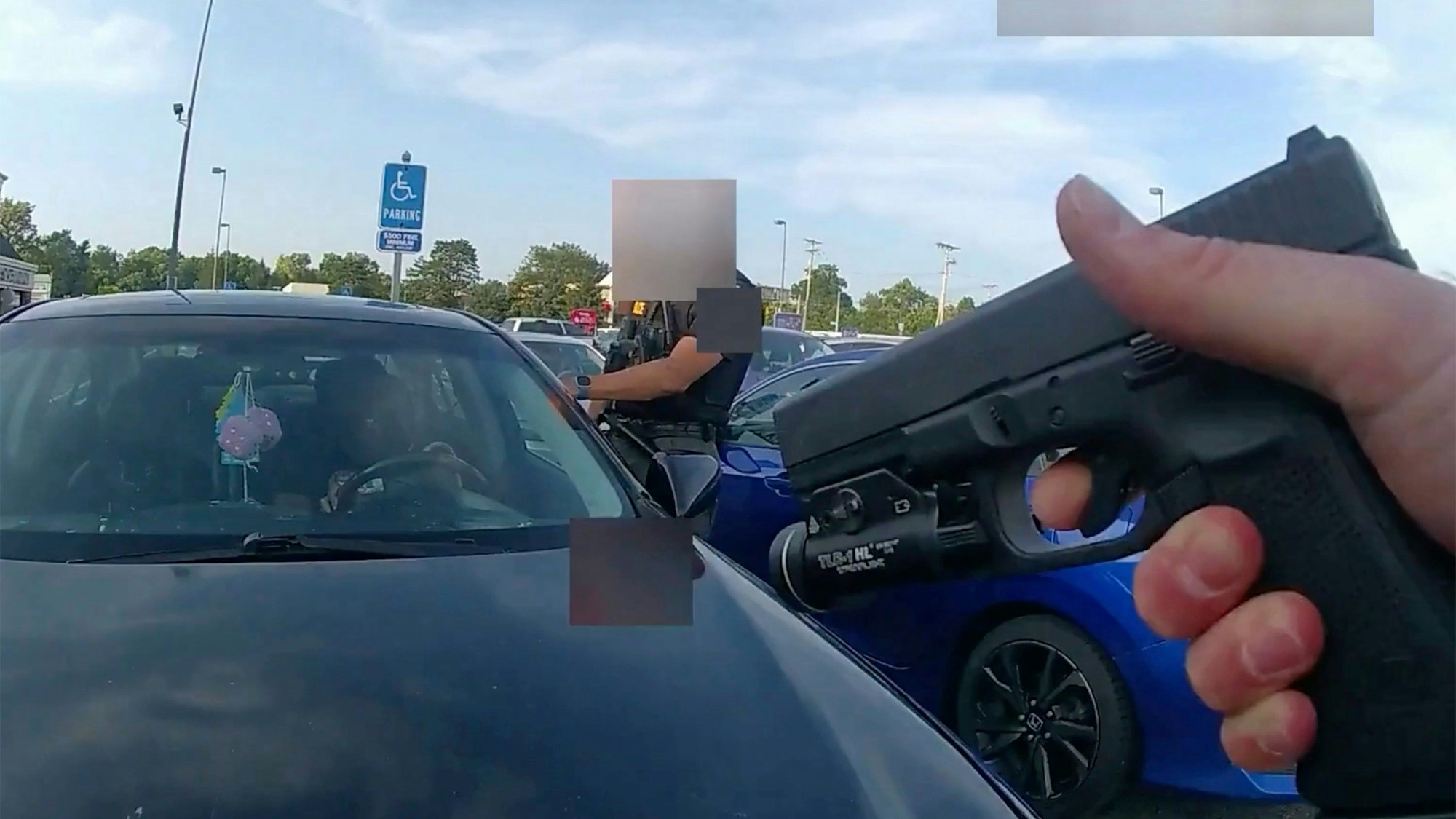 FILE - This image from bodycam video released by the Blendon Township Police on Friday, Sept. 1, 2023, shows an officer pointing his gun at Ta'Kiya Young moments before shooting her through the windshield outside a grocery store in Blendon Township, Ohio, a suburb of Columbus, on Aug. 24. The pregnant Black mother was pronounced dead shortly after the shooting. Her unborn daughter did not survive. The image was pixelated by the source. (Blendon Township Police via AP, File)