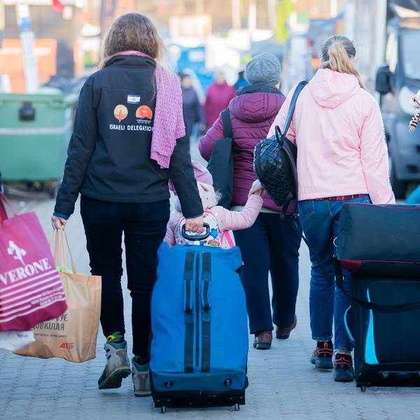 Frauen und Kinder, die aus der Ukraine geflohen sind, werden am Grenzübergang kurz hinter der ukrainischen Grenze, auf polnischer Seite, von einer freiwilligen Helferin (l.) begleitet. (Symbolbild)
