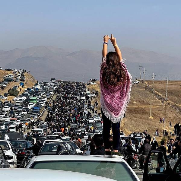 (FILES) This file UGC image posted on Twitter reportedly on October 26, 2022 shows an unveiled woman standing on top of a vehicle as thousands make their way towards Aichi cemetery in Saqez, Mahsa Amini's home town in the western Iranian province of Kurdistan, to mark 40 days since her death, defying heightened security measures as part of a bloody crackdown on women-led protests. - Mahsa Amini was an Iranian woman like any other, but she went down in history as one influential figure for her death on September 16 gave rise to a protest movement which, after six months, continues to affect the society.