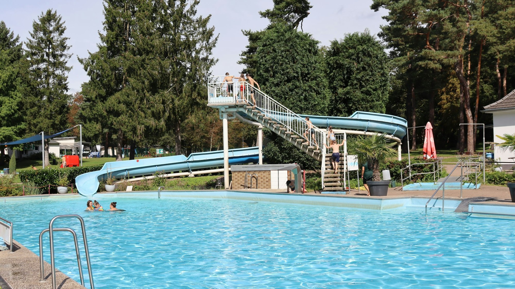 Das Becken eines Freibades mit einer Rutsche ist zu sehen.