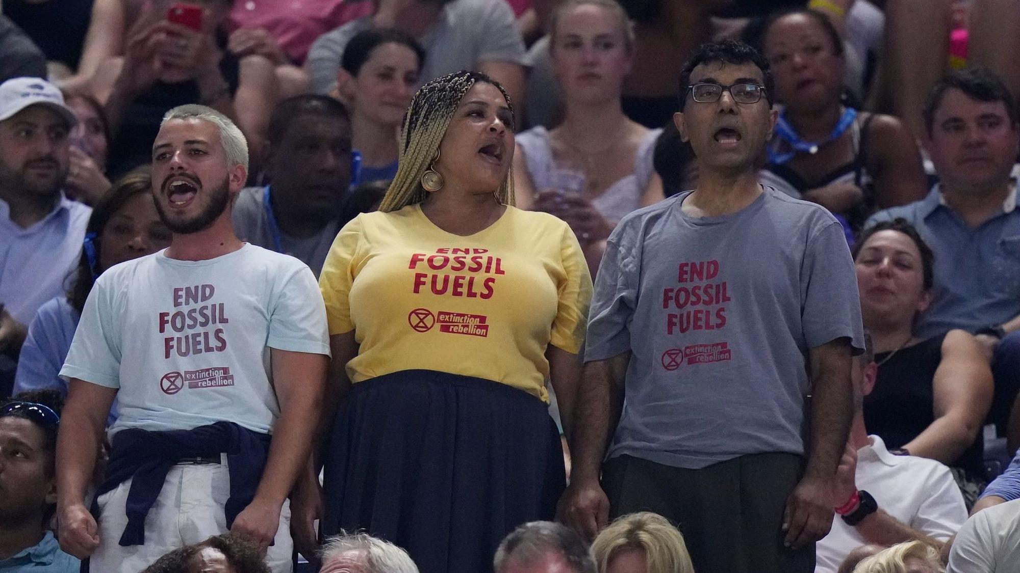 Protesters demonstrate at a match between Coco Gauff, of the United States, and Karolina Muchova, of the Czech Republic, during the women's singles semifinals of the U.S. Open tennis championships, Thursday, Sept. 7, 2023, in New York. (AP Photo/Frank Franklin II)