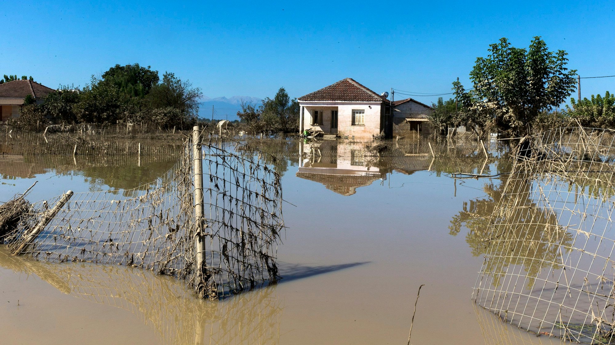 12.09.2023, Griechenland, Metamorfosi: Ein Haus steht inmitten von Wassermassen. In den von Überschwemmungen betroffenen Gebieten Mittelgriechenlands sind die Wasserstände weiter gesunken. Foto: Marios Lolos/XinHua/dpa +++ dpa-Bildfunk +++