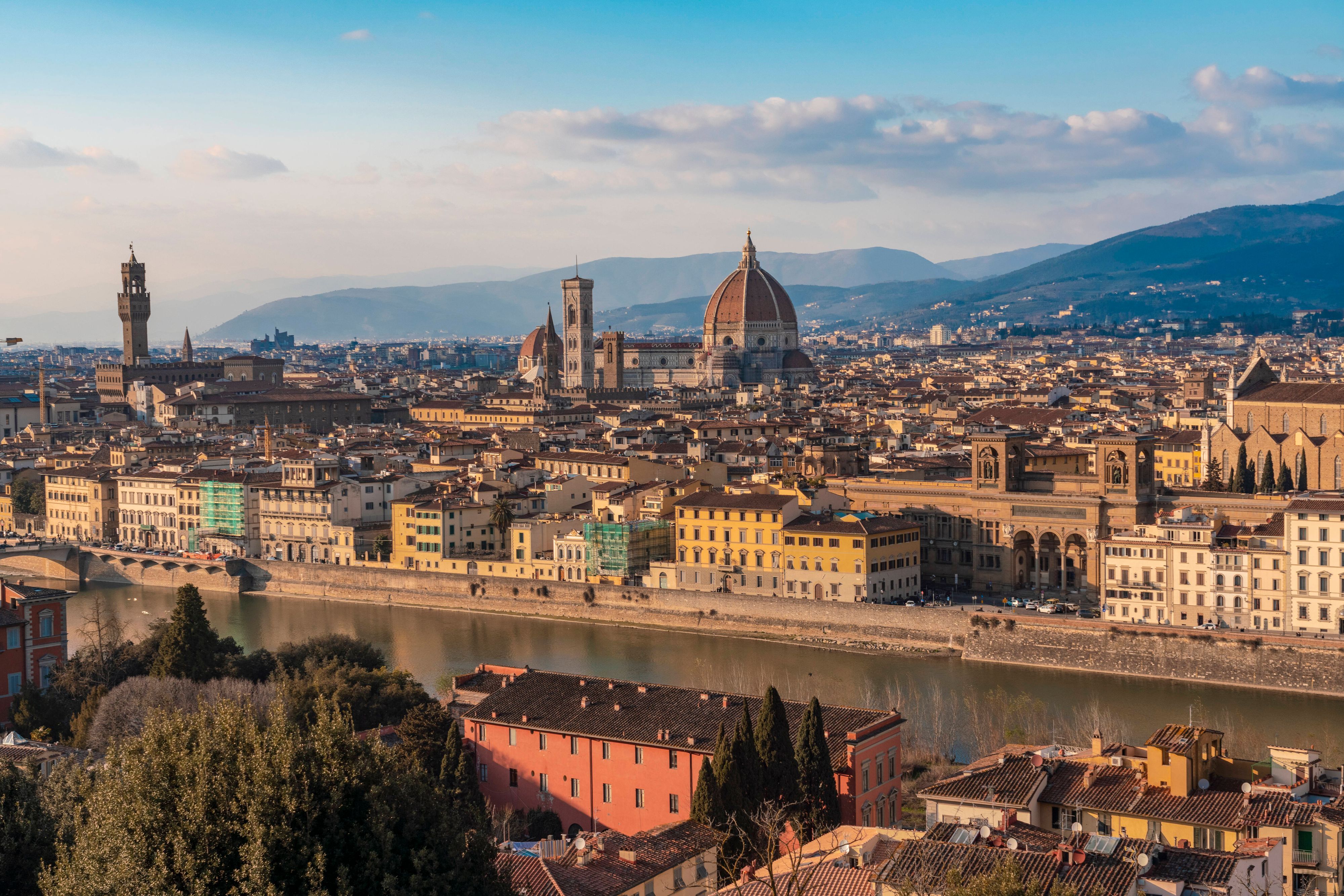 Italy, Tuscany, Florence, Arno River with Florence Cathedral and surrounding buildings in background, Florence Toscana Italy TAMF03475
