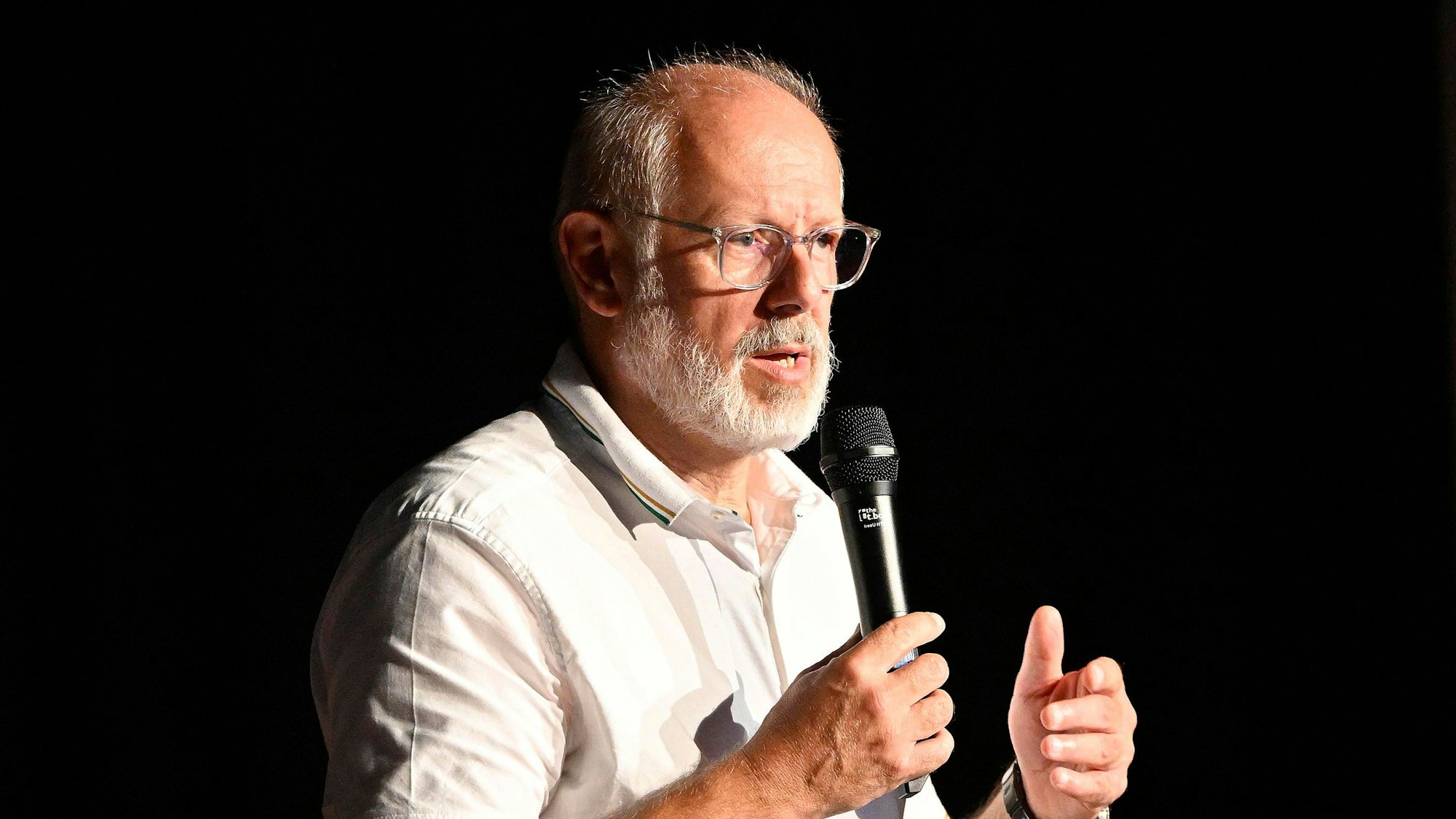 Zoodirektor Theo Pagel steht am Rednerpult mit einem Mikrofon in der Hand.