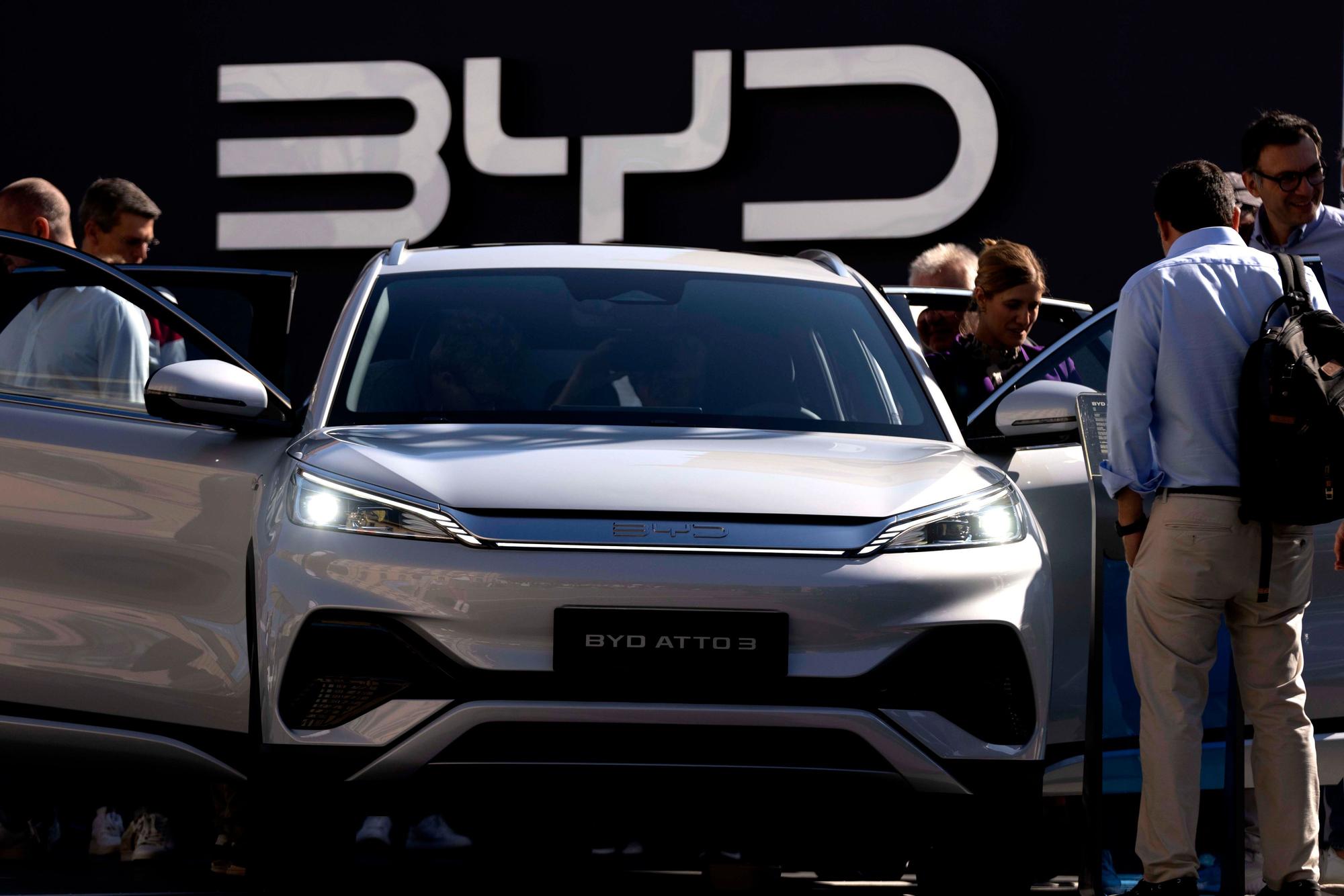 Visitors check the BYD ATTO 3 at the IAA motor show in Munich, Germany, Friday, Sept. 8, 2023. The international motor show IAA Mobility 2023 takes place in Munich from Sept. 5 until Sept. 10, 2023. (AP Photo/Matthias Schrader)