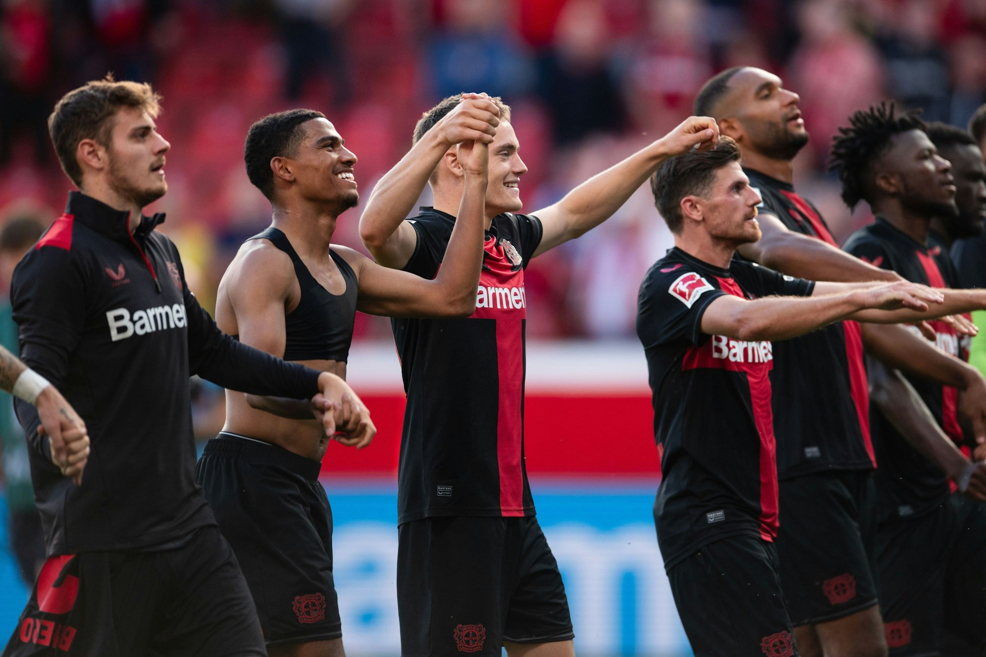 Bundesliga, Bayer Leverkusen - 1. FC Heidenheim, 5. Spieltag, BayArena. Leverkusens Amine Adli (2.v.l.-r), Florian Wirtz, Jonas Hofmann und Jonathan Tah feiern nach der Partie. Foto: Marius Becker/dpa - +
