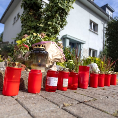 Kerzen stehen auf der Römerstrasse in Rodenkirchen. Ein 19-Jähriger wurde in Köln erstochen, ein Verdächtiger sitzt in U-Haft.