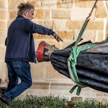dpatopbilder - 25.09.2023, Nordrhein-Westfalen, Essen: Die Skulptur des Essener Kardinals Franz Hengsbach hängt nach der Demontage vor dem Essener Dom an einem Kran und wird verladen. Das Bistum Essen hatte mitgeteilt, dass der «gravierende» Verdacht bestehe, Hengsbach könnte in seiner Zeit als Weihbischof in Paderborn eine 16-Jährige sexuell missbraucht haben. - recrop Foto: Christoph Reichwein/dpa +++ dpa-Bildfunk +++