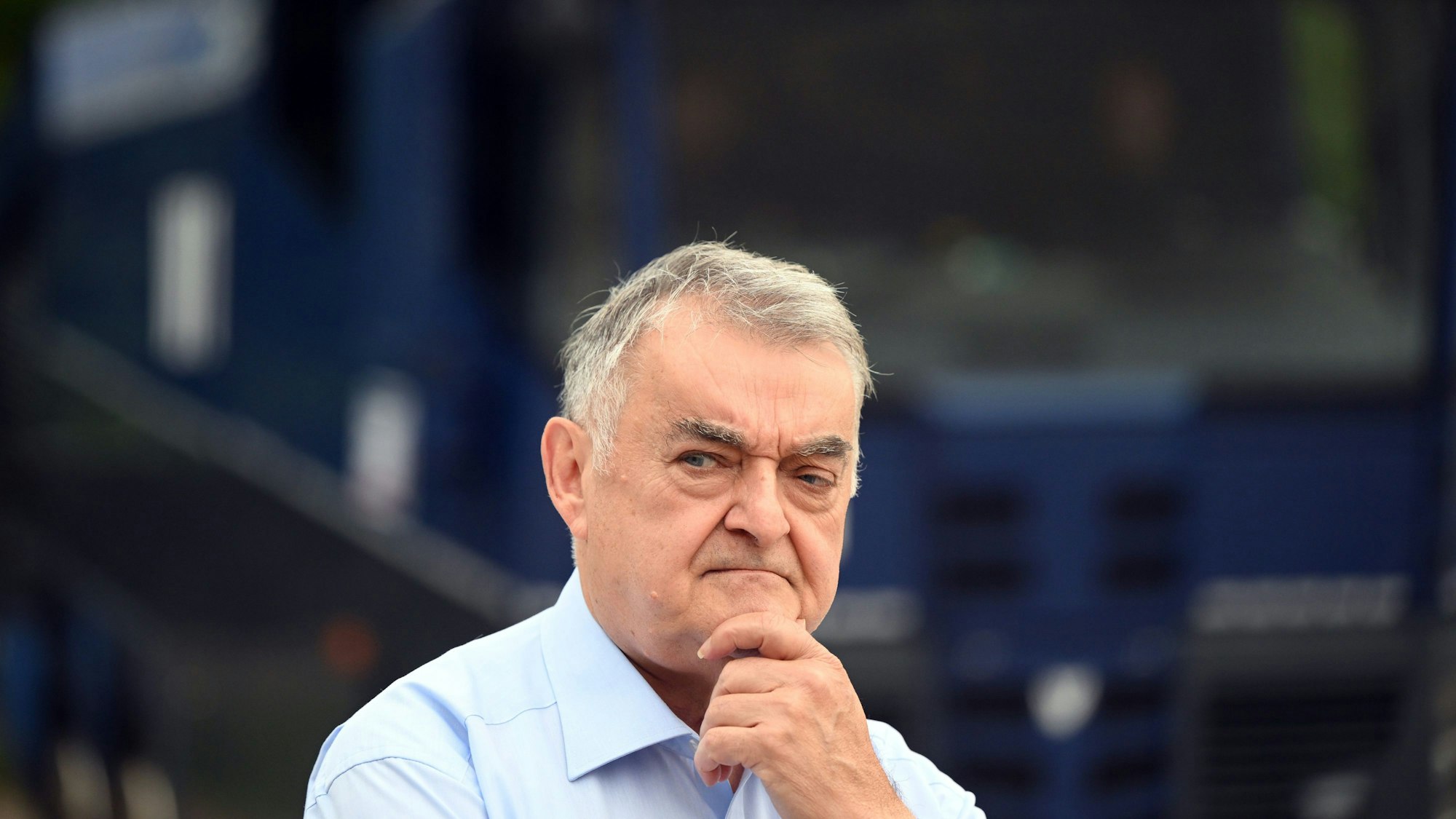 Auf dem Foto ist ein nachdenklich wirkender NRW-Innenminister Herbert Reul zu sehen. Er hält eine Hand an sein Kinn.