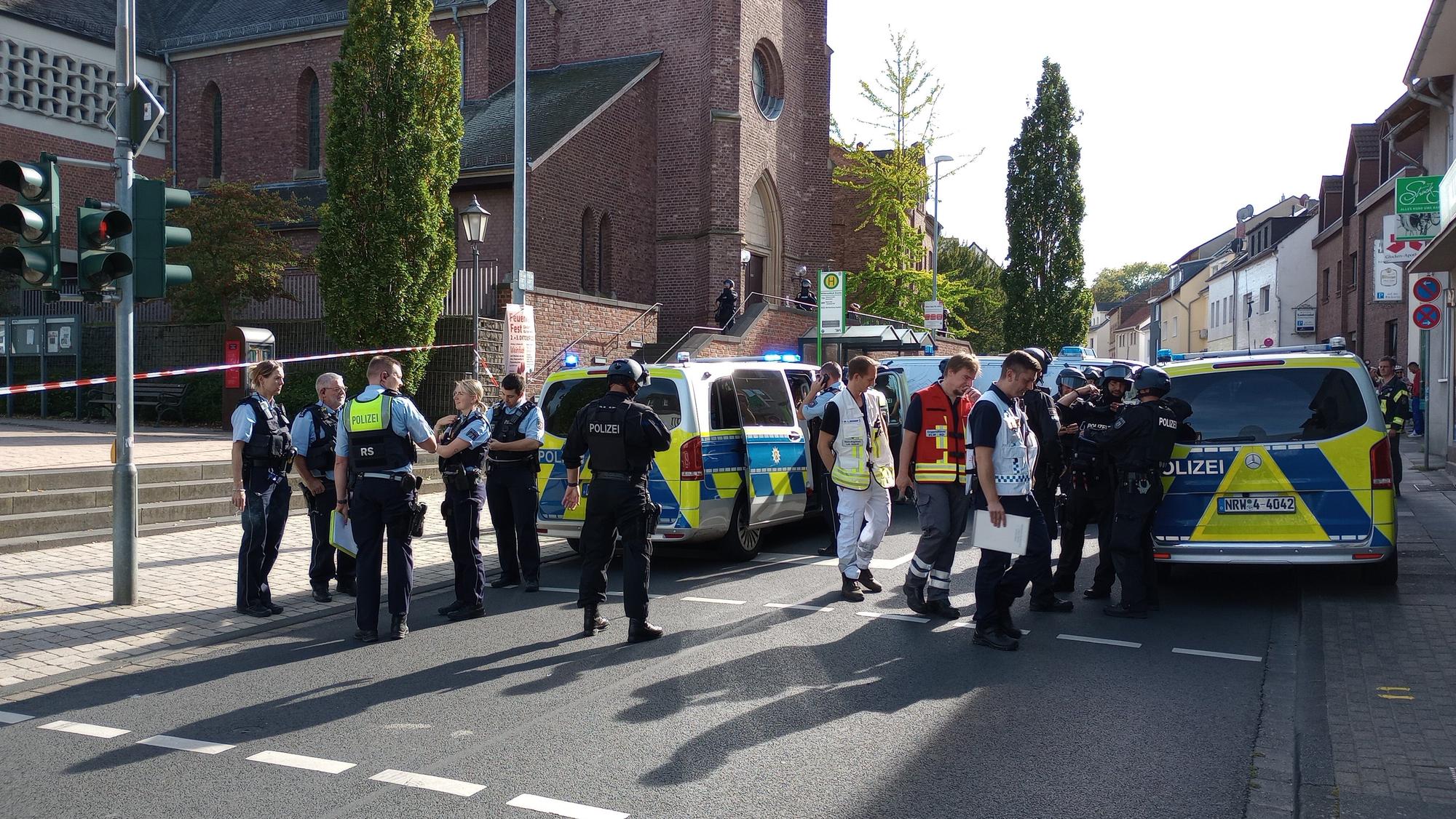 Einsatzkräfte stehen vor der katholischen Kirche Witterschlick