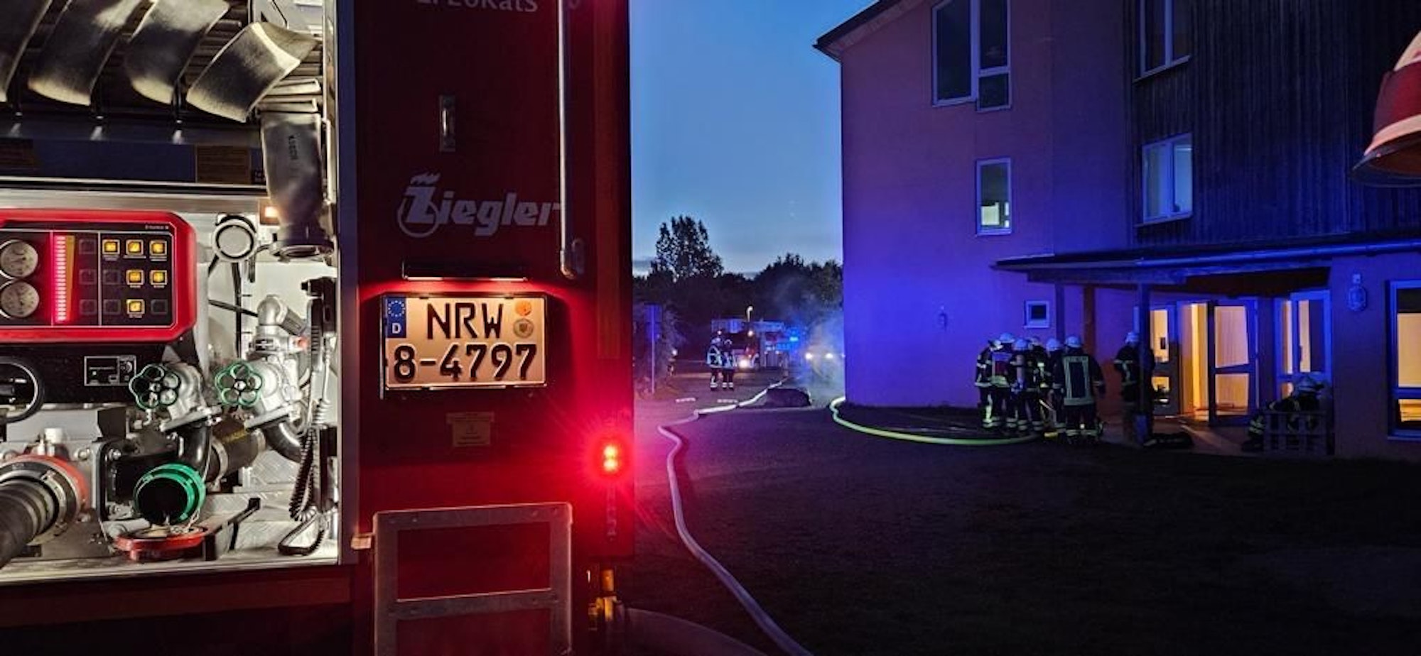 Ein Feuerwehrauto steht vor einem Gebäude.