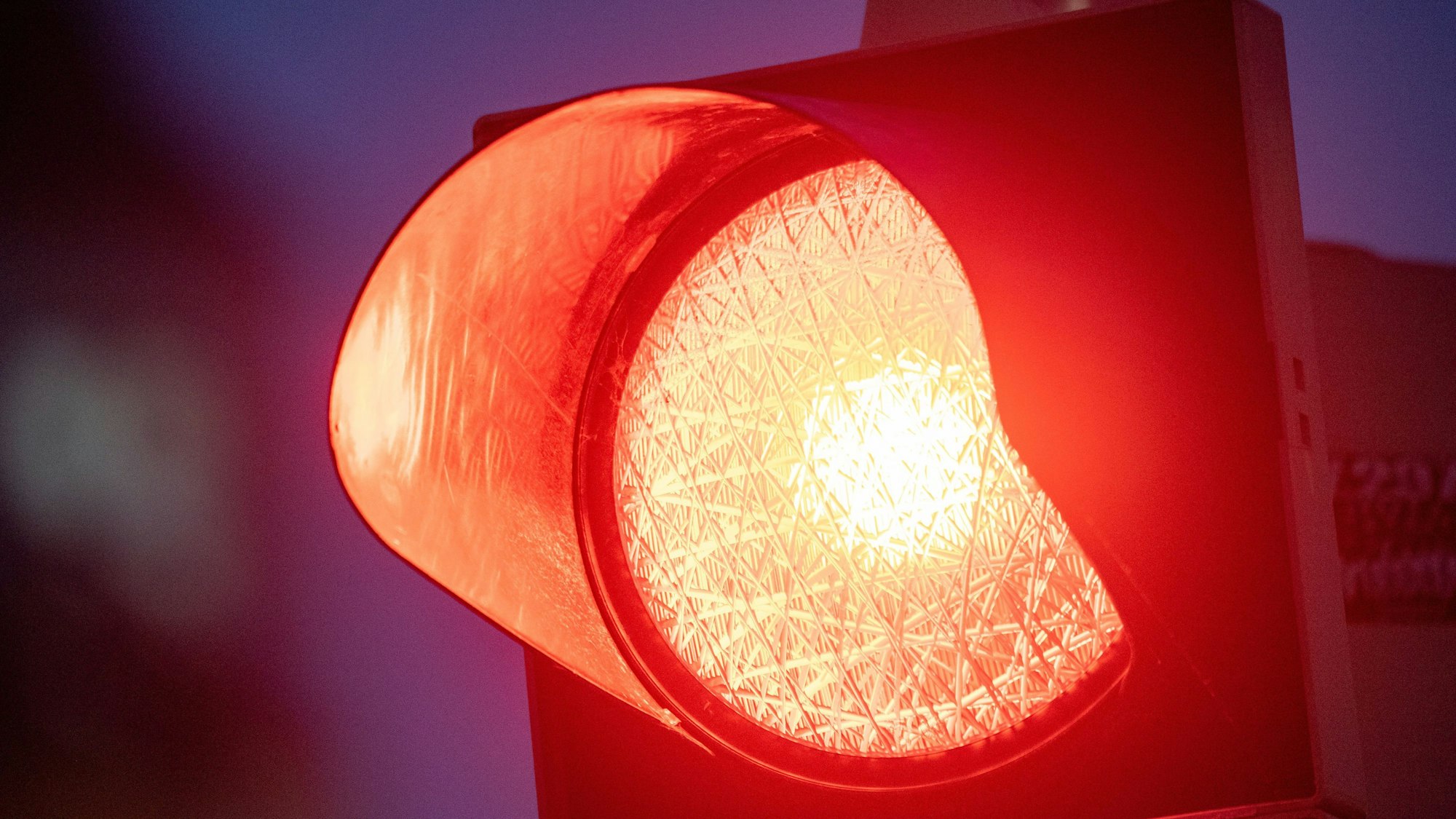 Eine rote Ampel leuchtet am Abend.