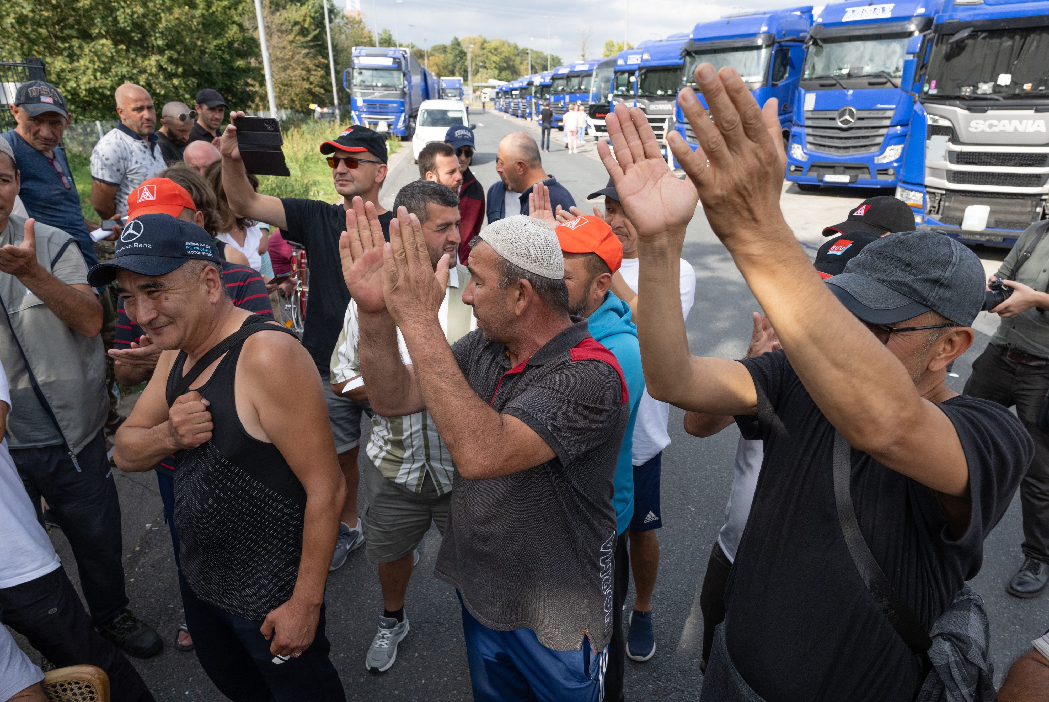 Trucker jubeln auf der Raststätte Gräfenhausen, wo sie seit mehr als zwei Monaten mit rund 80 anderen LKW-Fahrern für die Auszahlung seines Lohnes streiken.