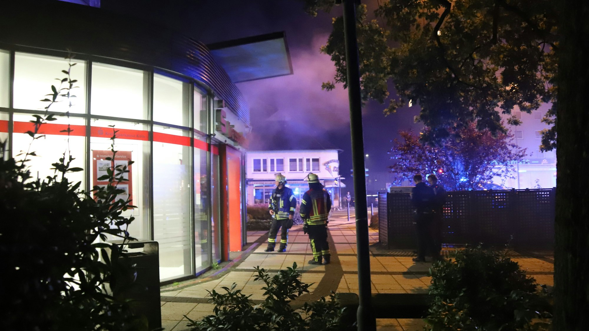 Die Kreissparkasse Köln an der Lohmarer Straße in Troisdorf war kurz nach Mitternacht verraucht, die Vernebelungsanlage hatte ausgelöst. Feuerwehrleute öffneten die Tür um zu lüften. Nebelschwaden zogen ins Freie.