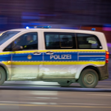 Ein Polizeiauto fährt mit Blaulicht zu einem Einsatz.