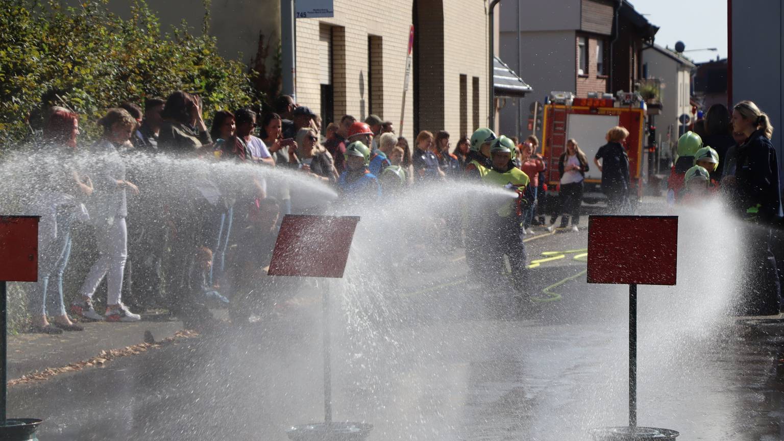 Feuerwehr-Kinder zeigen beim Okoberfest einen Löschangriff.