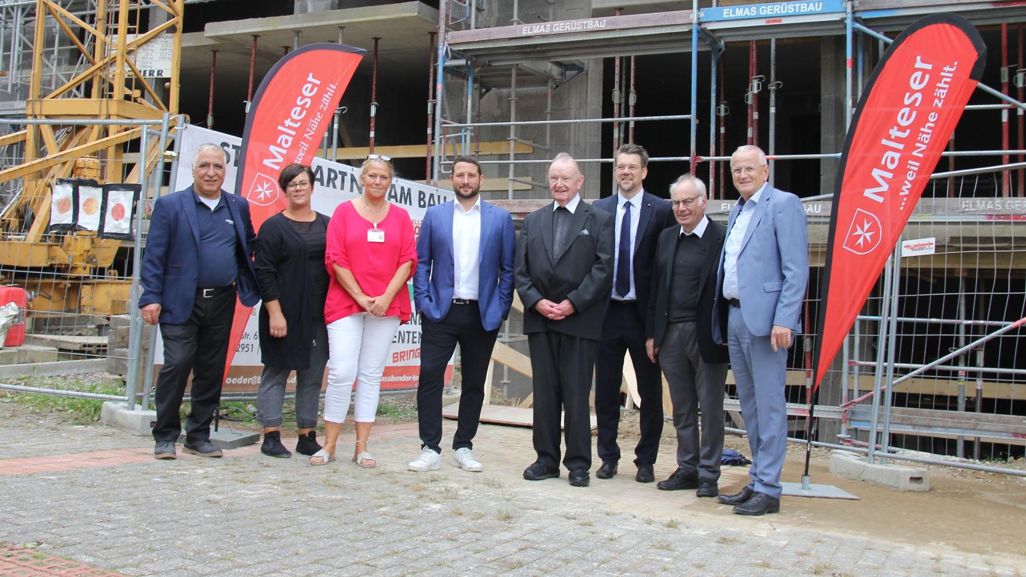 Architekt, Investor, Hausleitung und Overather Geistliche stehen vor der Baustelle.