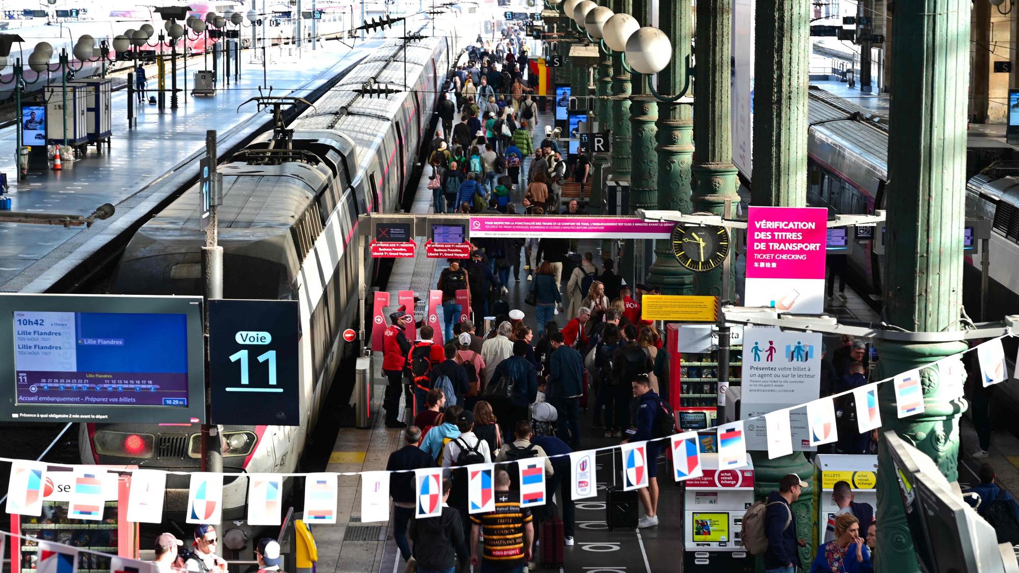 Passengers wait at the platforms of Paris' Gare du Nord station, on October 7, 2023. (Photo by MIGUEL MEDINA / AFP)
