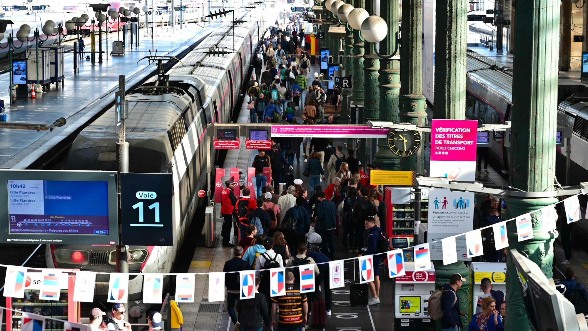 Passengers wait at the platforms of Paris' Gare du Nord station, on October 7, 2023. (Photo by MIGUEL MEDINA / AFP)