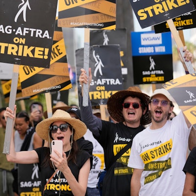 File - People picketing on behalf of the Screen Actors Guild-American Federation of Television and Radio Artists carry signs outside Netflix on Sept. 27, 2023, in Los Angeles. From auto production lines to Hollywood, the power of labor unions is back in the national spotlight. (AP Photo/Chris Pizzello, File)