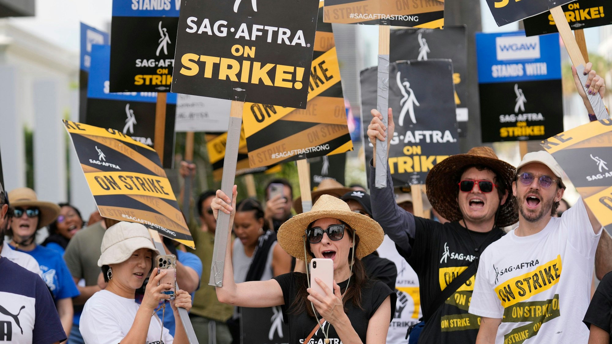File - People picketing on behalf of the Screen Actors Guild-American Federation of Television and Radio Artists carry signs outside Netflix on Sept. 27, 2023, in Los Angeles. From auto production lines to Hollywood, the power of labor unions is back in the national spotlight. (AP Photo/Chris Pizzello, File)