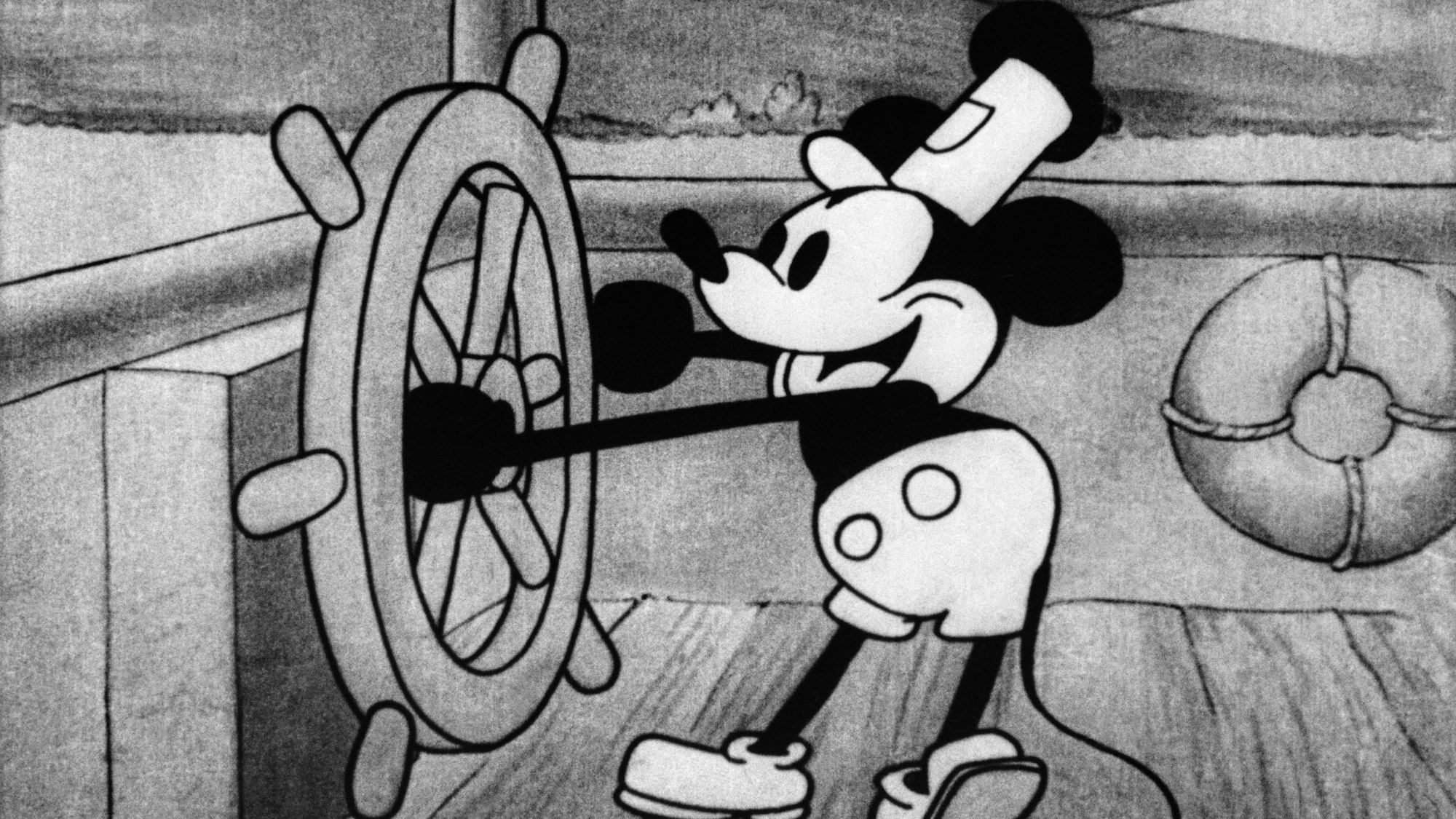 Die Zeichentrickfigur Micky Maus steuert ein Boot in einem Standbild aus dem Animationsfilm «Steamboat Willie» von Disney.