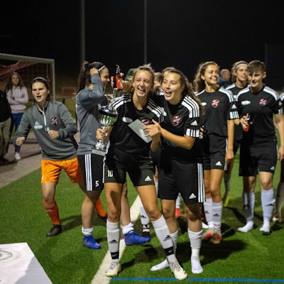 Eine Fußballspielerin jubelt über den Pokalsieg.