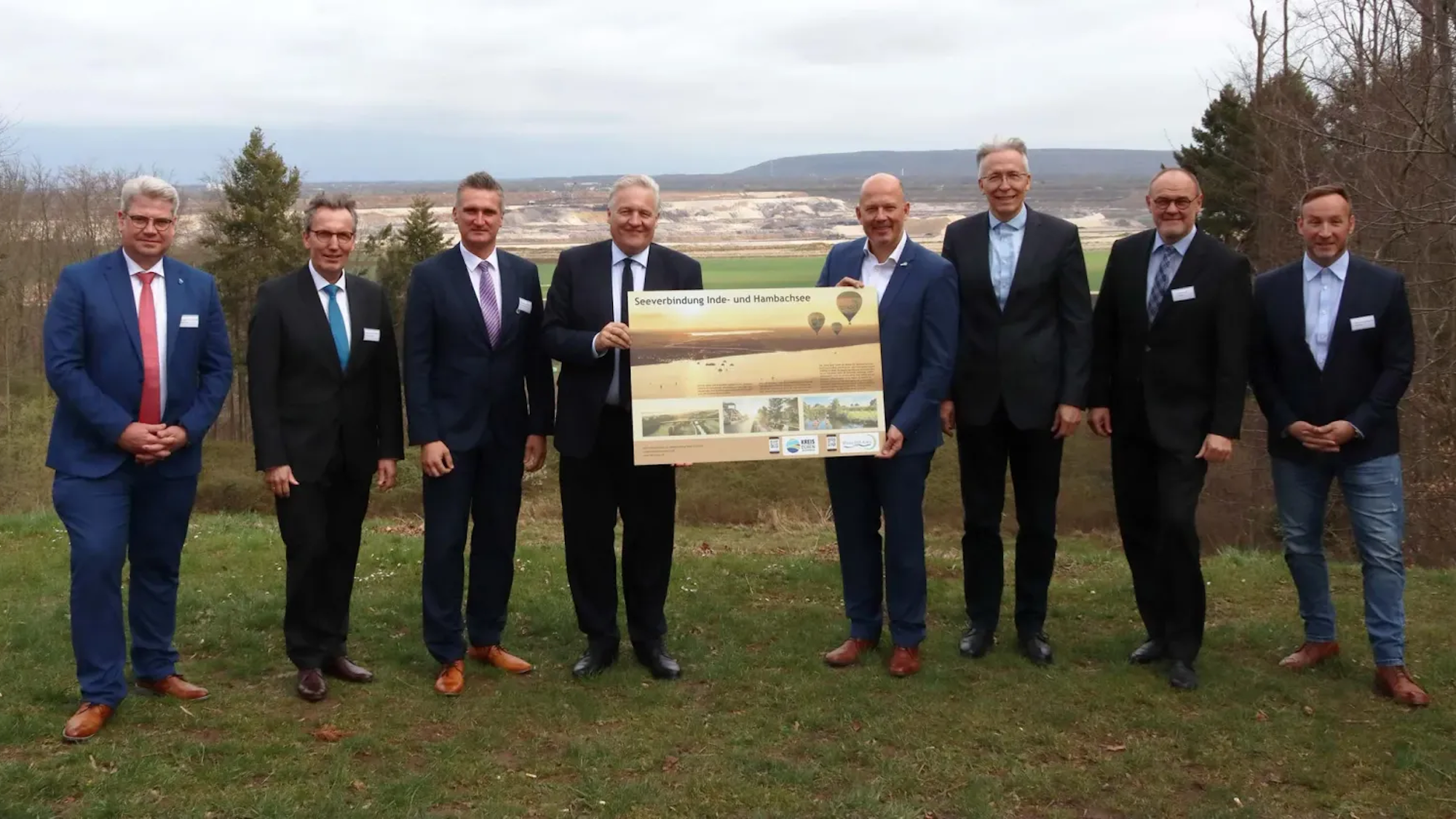 Auf dem Foto sind die Landräte der Kreise Düren und Rhein-Erft, Wolfgang Spelthahn und Frank Rock, und einige Bürgermeister zu sehen. Im Hintergrund ist Tagebau zu sehen.