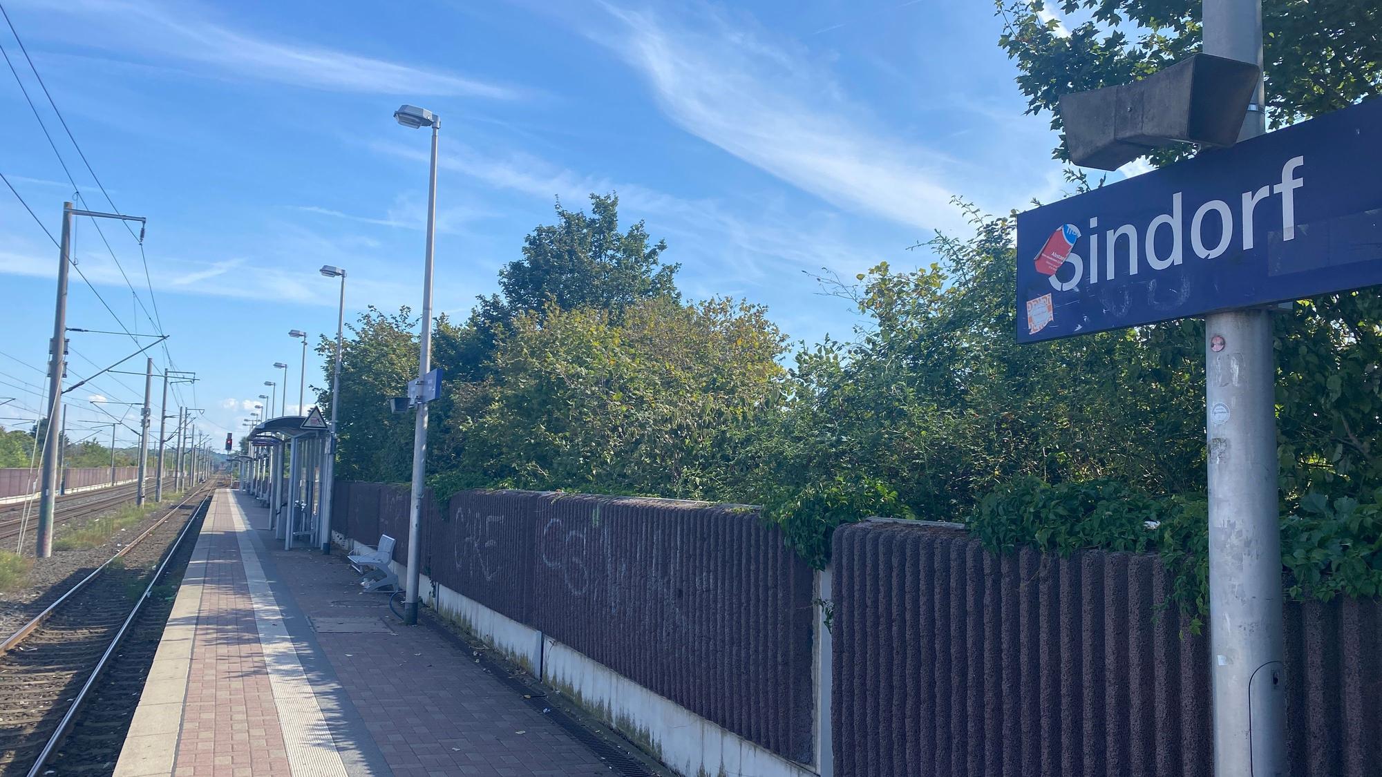 Die Bahnstation in Sindorf. An einer Schallschutzmauer ist Graffiti.