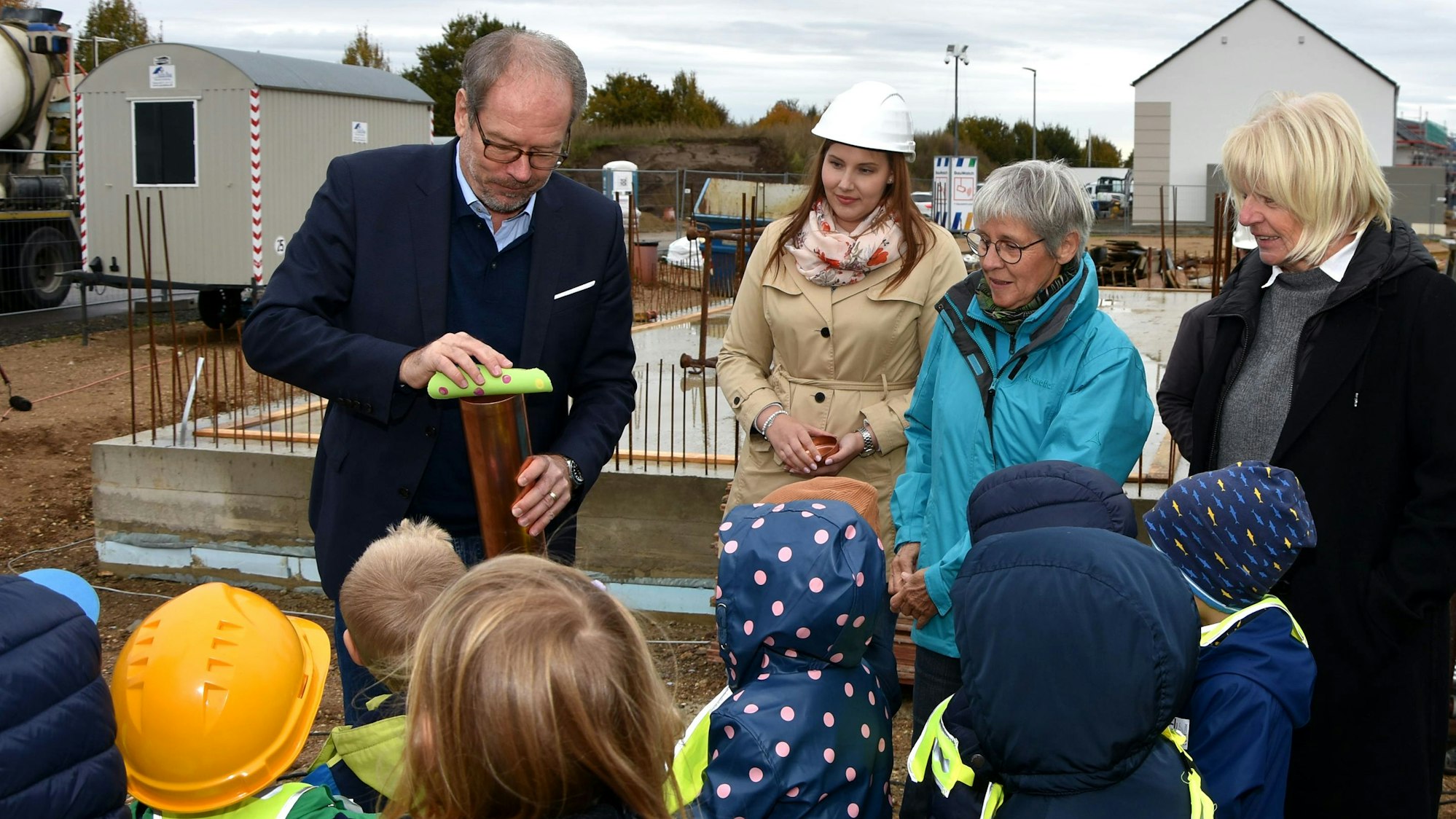 Auf dem Foto sind Bergheims Bürgermeister Volker Mießeler und Kinder der Kita „Rasselbande“ zu sehen.