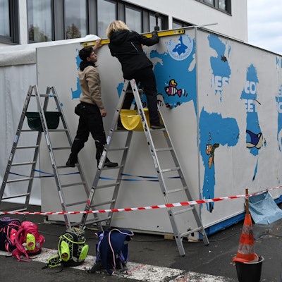 An einem großen Container wird gearbeitet.