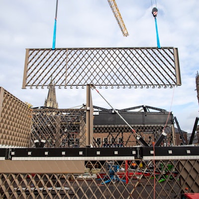 Ein Stahlbauteil mit Rautenmuster wird an der MiQua-Baustelle angeliefert.