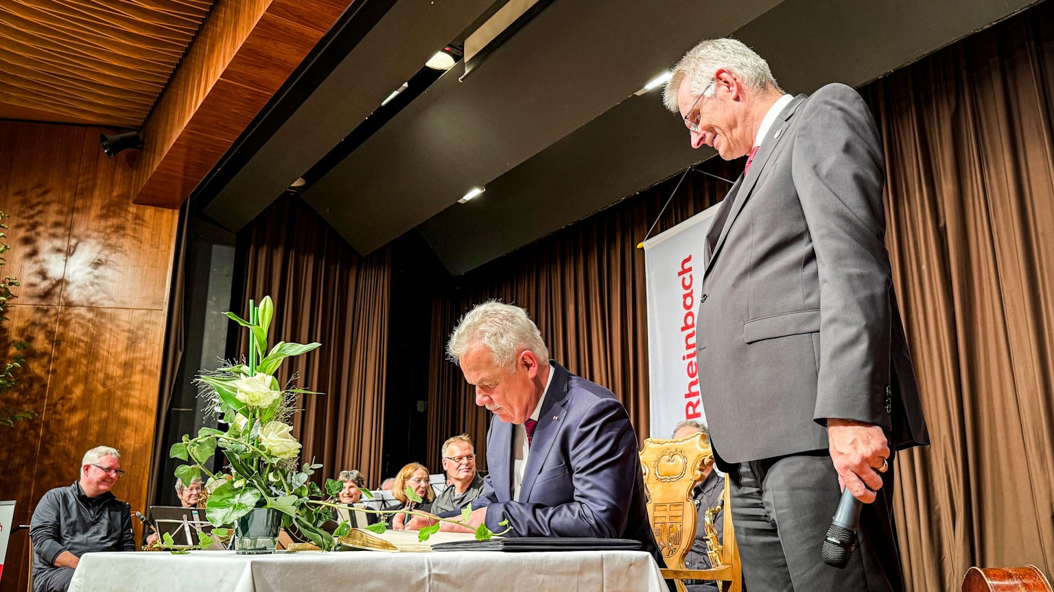 Stefan Raetz erhält die Ehrenbürgerschaft der Stadt Rheinbach. Er trägt sich ins Goldene Buch ein. Foto: Meike Böschemeyer