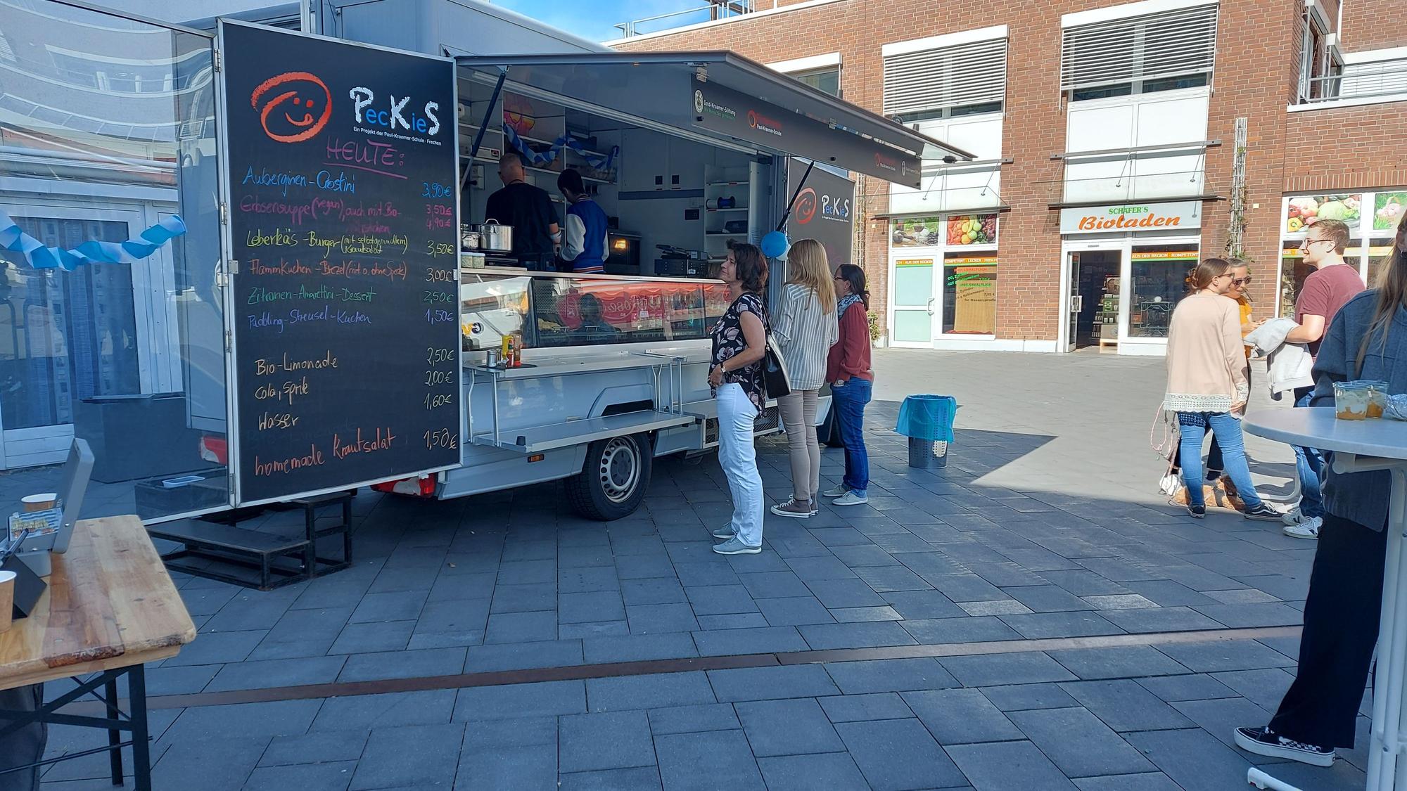 Auf dem Bild ist ein Foodtruck zu sehen, an dem Schüler Speisen und Getränke verkaufen.