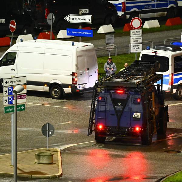 Polizeiautos und ein Spezialfahrzeug stehen am Flughafen. Der Hamburger Flughafen ist nach dem Eindringen eines Fahrzeugs auf das Gelände gesperrt worden.