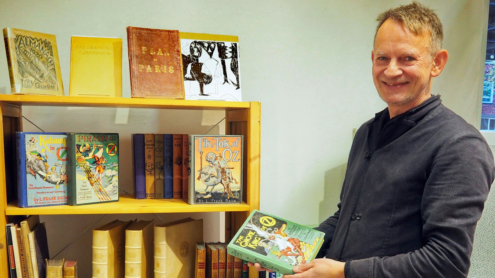 Ein Mann hält ein Buch in der Hand.