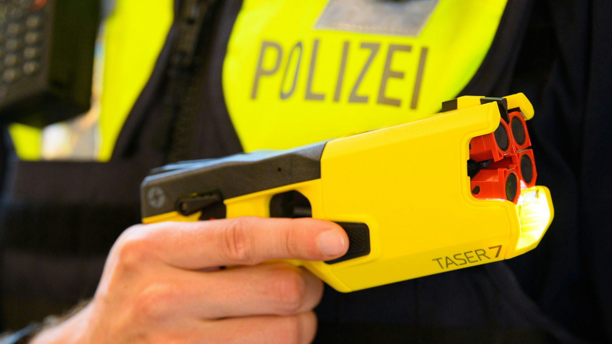 Ein Polizeibeamter hält einen Taser 7 in der Hand. (Symbolbild)
