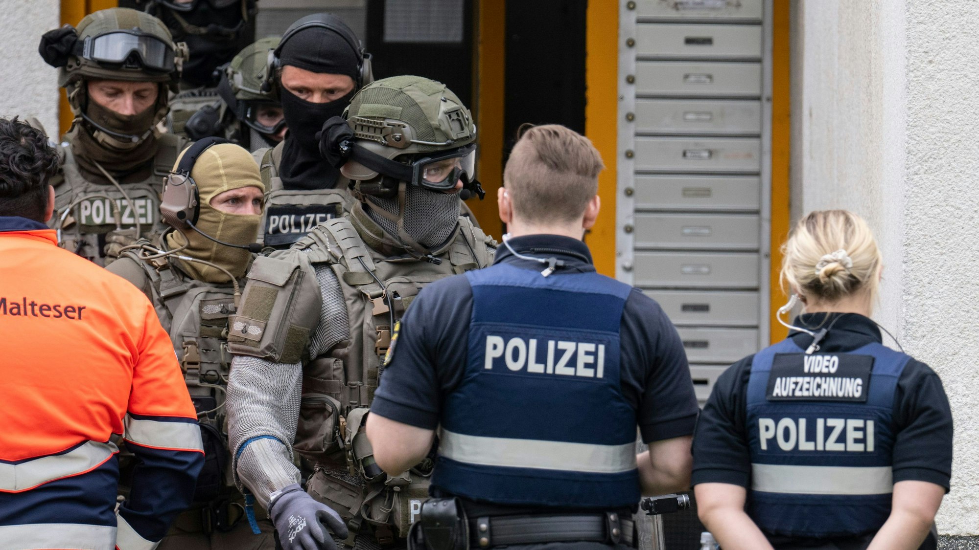 Polizisten eines Sondereinsatzkommandos (SEK) stehen an einem Gebäude. In Salzgitter räumt ein SEK eine Schule bei einem Großeinsatz. (Symbolbild)