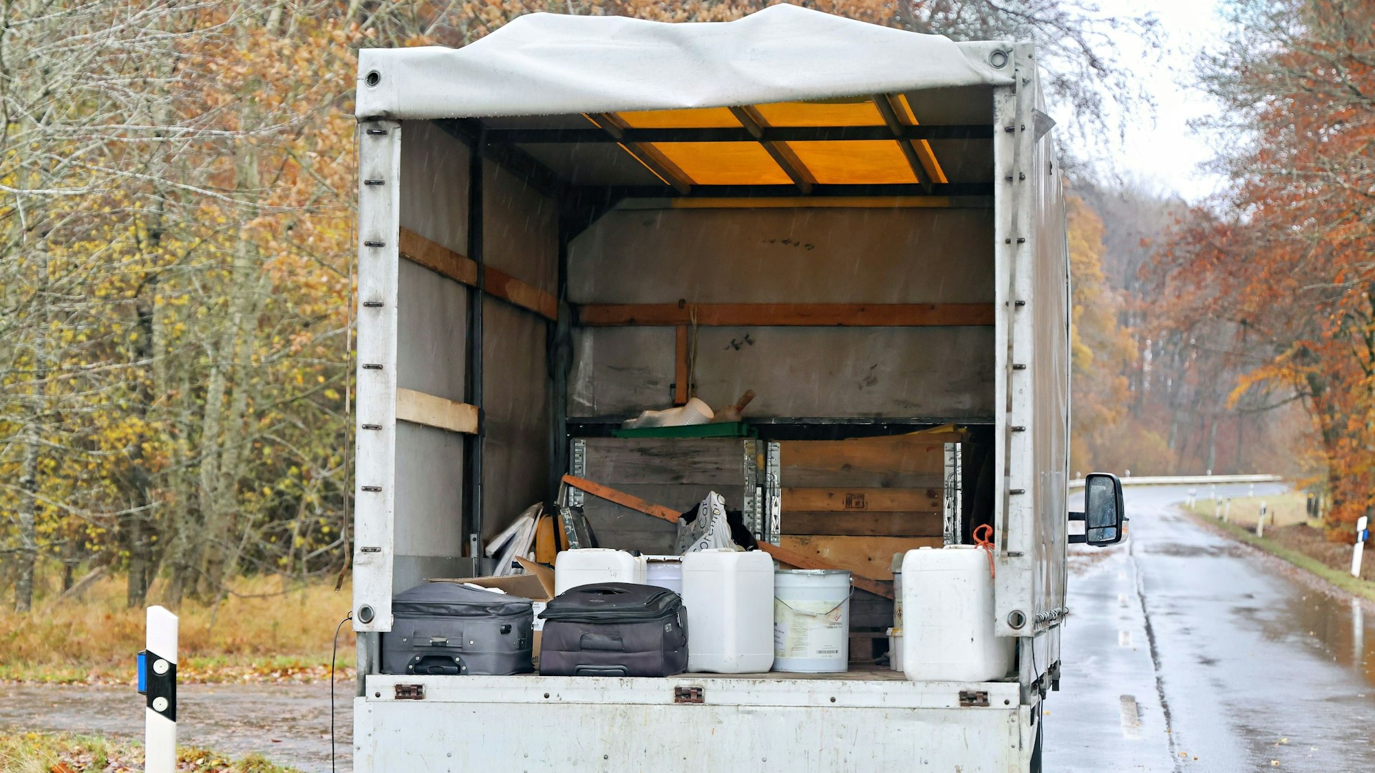 Auf der geöffneten Ladefläche des Kleinlasters sind mehrere ungesicherte Kanister zu erkennen.